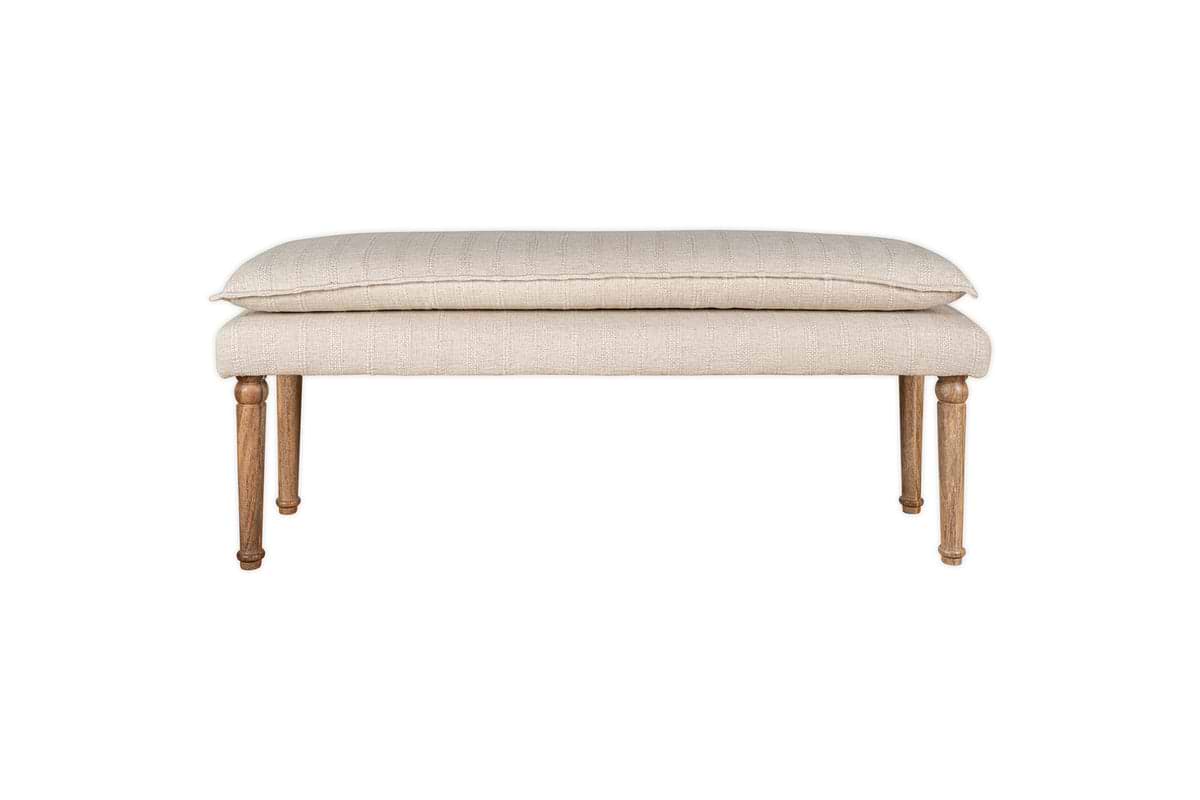 The Kiana Cotton Upholstered Bench by nkuku features a cushioned seat and wooden legs in a natural finish—an elegant accent piece for any room, shown against a white background.