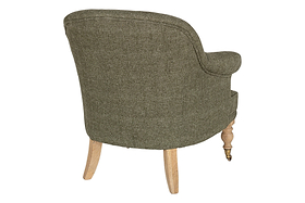 The Kiana Cotton Armchair - Moss by nkuku is shown from the back. It features green cotton upholstery, a curved backrest, tub shape, hand-carved light mango wood legs, and a small metal caster on one front leg against a white background.