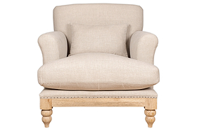 The nkuku Kashi Linen Armchair in natural beige features a solid mango wood frame with turned legs, rounded armrests, natural linen upholstery, and a matching cushion, shown from the front on a white background.