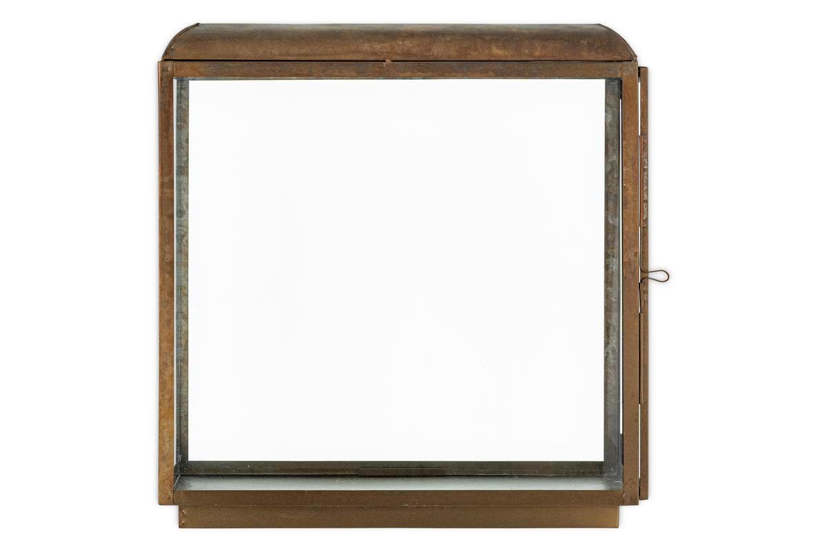 The Kiwanda Tall Lantern by nkuku features an antique brass finish, clear glass panels, a flat base, and a rounded top. It’s ideal for candlelight décor and has a side latch to open the front door.