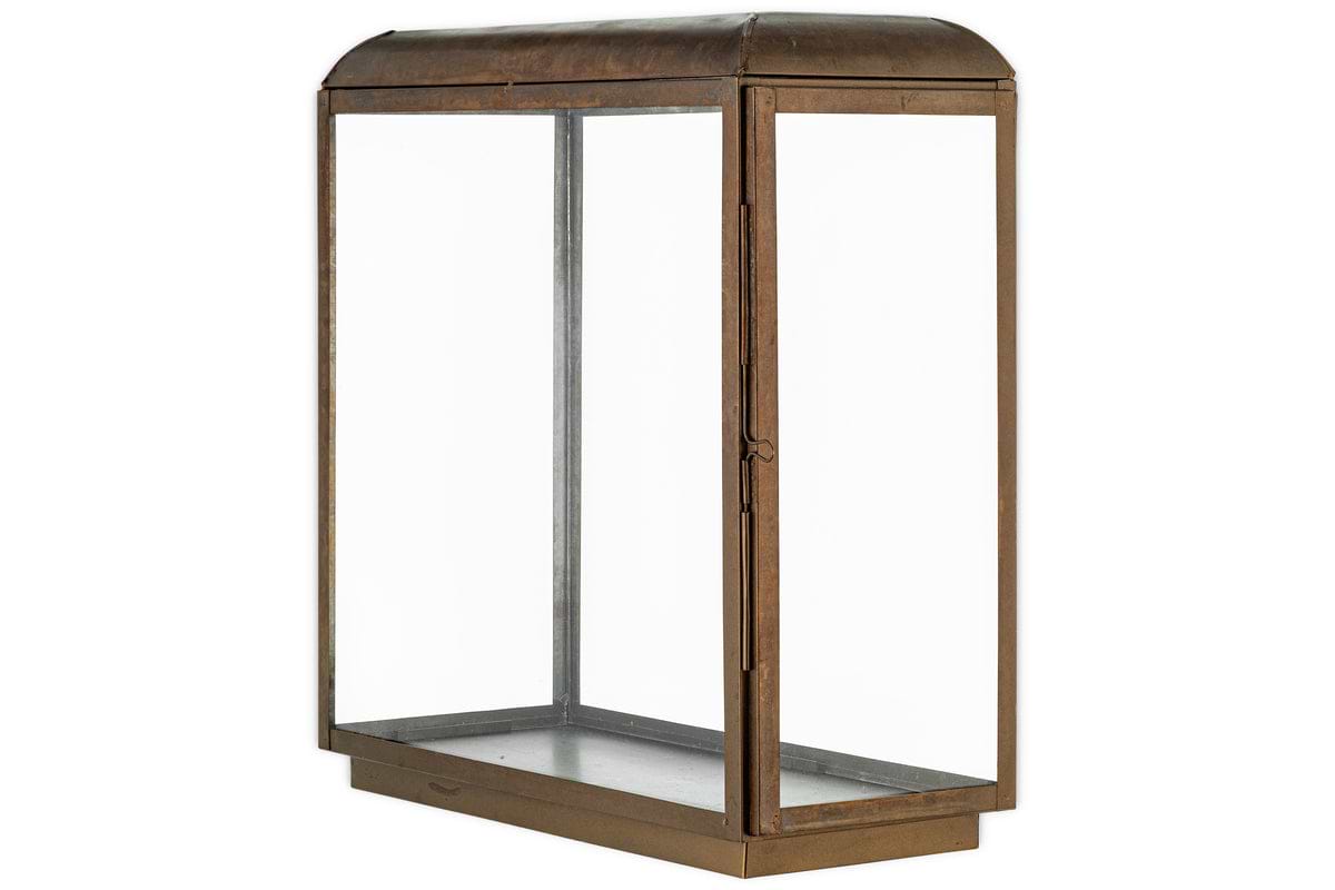 The Kiwanda Tall Lantern by nkuku features an antique brass frame and domed glass top, inspired by vintage lanterns. It has a hinged side door and is shown empty against a plain white background.