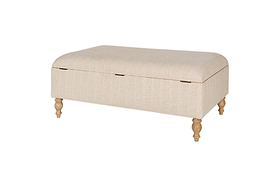 The Kiana Upholstered Storage Ottoman - Natural by nkuku features a beige fabric, hinged lid, and four light wooden legs, blending style and function for your living space. Shown against a white background.