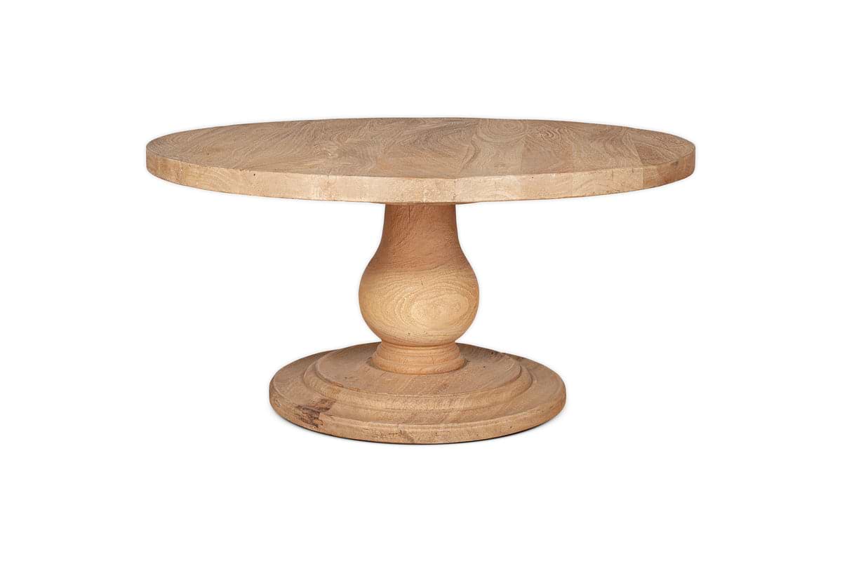 The nkuku Laya Round Carved Coffee Table - Natural features a sculptural wooden form and thick base, showcasing natural wood grain and a raw wood finish, displayed on a white background.
