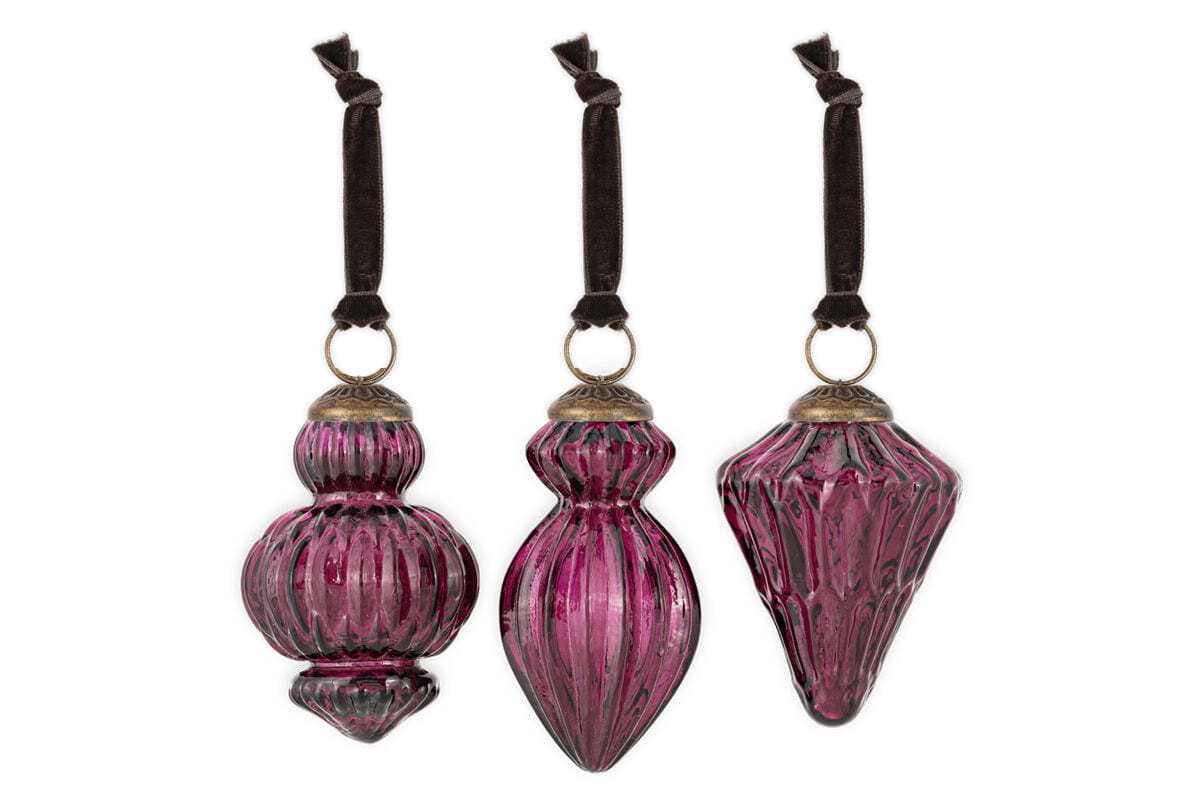 The Manipur Baubles - Ruby (Set of 3) by nkuku features unique ribbed glass ornaments in deep ruby, each with an antique gold top and brown velvet ribbon, displayed against a plain white background.