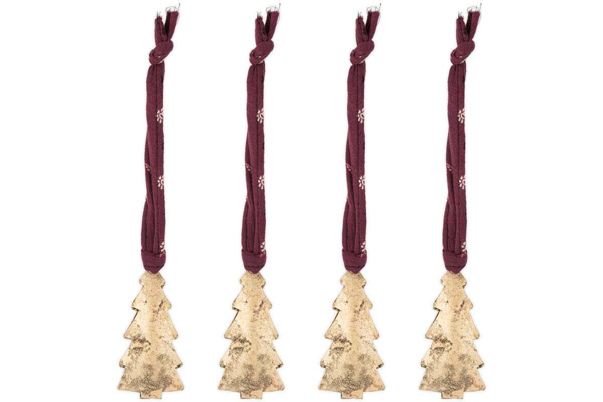 The nkuku Mishti Tree Baubles - Antique Brass - Small (Set of 4) feature gold-colored iron ornaments in tree shapes, each hanging from a burgundy ribbon with white snowflakes and finished in antique brass. Perfect for festive decorating.
