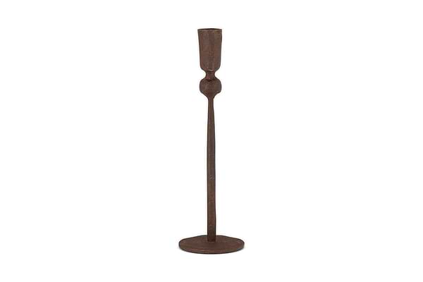 The Mawindi Candle Holder - Rust by nkuku is a tall, slender iron candlestick with a round base and minimalist design in dark brown, perfect for adding an earthy touch to your decor.