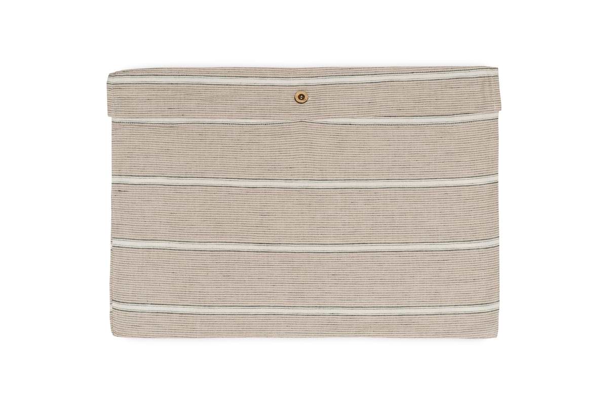 The Mora Hemp & Cotton Duvet Cover by nkuku, shown in stone grey, features horizontal black stripes and a flap closure with a single gold snap button, displayed against a white background.