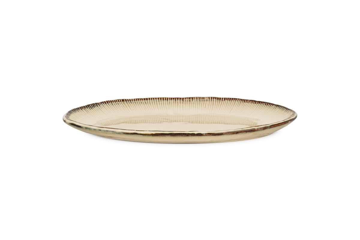 The nkuku Malia Large Oval Platter in cream features an organic shape, beige and brown reactive glaze, and a subtle ribbed rim texture, shown on a plain white background.