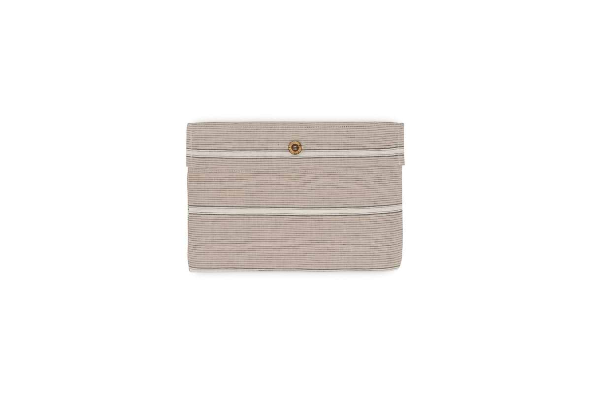A beige fabric pouch with thin stripes, a flap closure, and a central brown button pairs beautifully with the nkuku Mora Hemp & Cotton Housewife Pillowcases in Stone Grey. Perfect for neutral decor, its displayed against a white background.