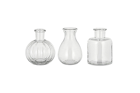 The nkuku Mayumi Recycled Glass Bud Vases - Clear (Set of 3) features three uniquely shaped clear vases, perfect for showcasing your favorite stems as elegant bud vases.