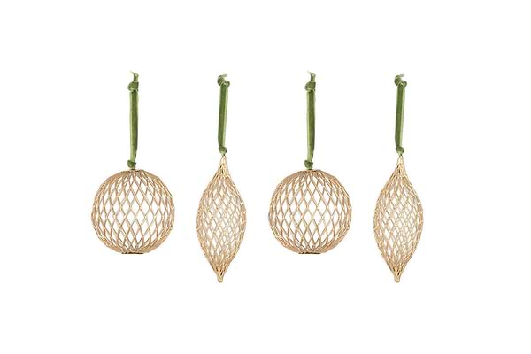 The Nirav Wire Baubles - Brass (Set of 4) by nkuku feature open lattice geometric shapes in a brass finish. Hanging from green velvet ribbons, the set includes two round, one elongated pointed, and one wide pointed bauble.