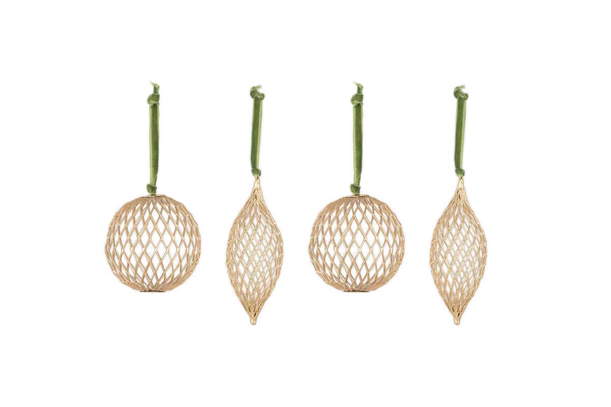 The Nirav Wire Baubles - Brass (Set of 4) by nkuku feature open lattice geometric shapes in a brass finish. Hanging from green velvet ribbons, the set includes two round, one elongated pointed, and one wide pointed bauble.