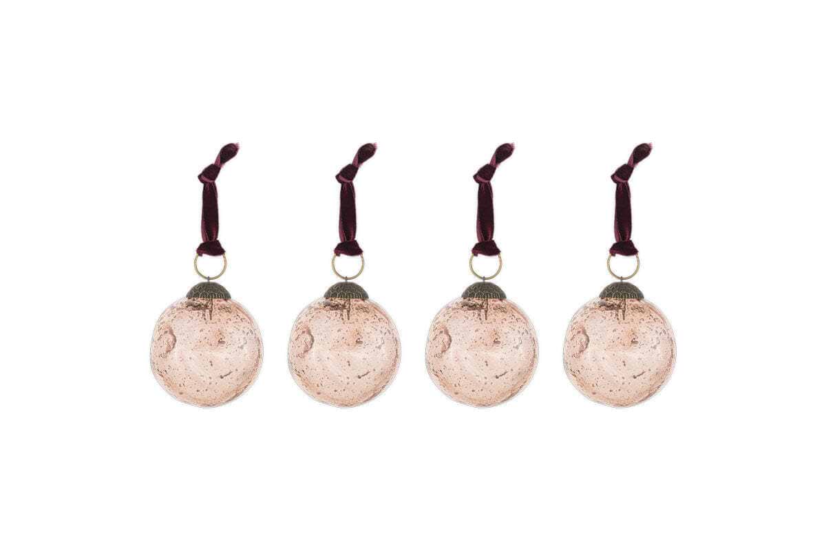 The nkuku Nishan Pinched Baubles - Copper (Set of 4) features four round, recycled glass baubles with a speckled vintage finish and burgundy velvet ties—perfect festive decorations for your holiday home.