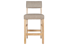 The nkuku Nadeeka Linen Upholstered Counter Chair in Soft Grey features a simple, modern design with a natural wood frame and legs. Its soft grey linen seat and backrest are shown from the front against a white background—ideal for kitchen islands.