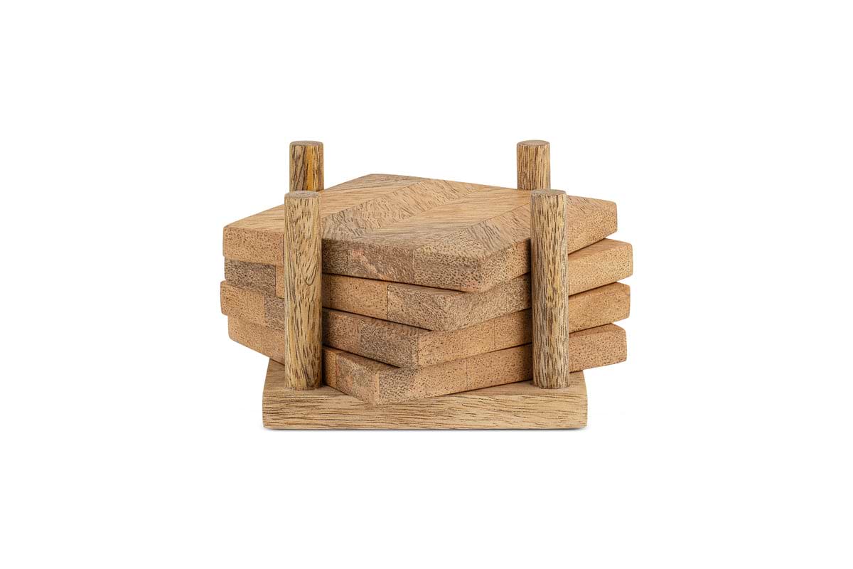 The Nalbari Coasters - Natural (Set of 4) by nkuku features four sustainable, hexagonal mango wood coasters in a light finish, neatly stacked on a square holder with two vertical posts.