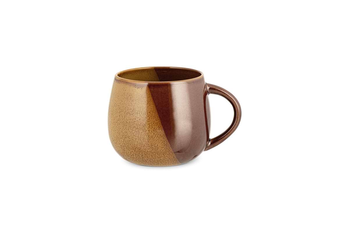 The Naav Mug - Mustard (Extra Large) by nkuku features a rounded shape with handle, showcasing a glossy mustard glaze on one side and a matte, speckled tan finish on the other, set against a white background.