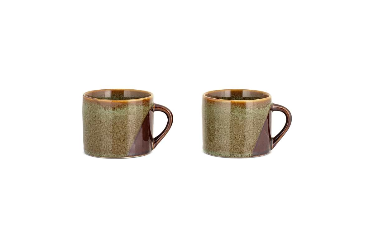 The Naav Mugs - Blue - Small (Set of 2) by nkuku, featuring handles and a unique blue glaze, are placed side by side on a white background.