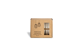 A small brown box labeled "Piani Hanging Paper Decoration - Moss Green - Set of 4" by nkuku, with illustrations of paper decorations. The window shows two rolled green honeycomb eggs inside. White background.