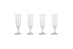 The Pani Champagne Flute - Clear (Set of 4) by nkuku features recycled glass flutes with tall, narrow bowls, slender stems, and round bases, beautifully arranged in a straight line against a plain white background.