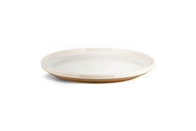 The Edo Dinnerware Set - Terracotta by nkuku features 12 minimalist, round ceramic plates with glossy white interiors and matte tan rims and bases. The design's earthy tones and lack of decoration create a serene, stylish tabletop look.