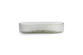 The Ilcoso Recycled Hammered Glass Soap Dish by nkuku features clear, rectangular glass with rounded corners, a low wide profile, and a subtle wavy texture. Shown empty against a plain white background.