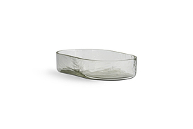 The Ilcoso Recycled Hammered Glass Soap Dish by nkuku features a clear, oval shape with textured sides and a smooth rim. Its subtle tint and handcrafted look make this unique recycled glass piece a stylish bathroom accessory.