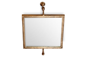 The Visala Swivel Wall Mirror by nkuku features a square, thick antique brass frame and pipe-style supports with exposed hardware, creating an industrial look against a white backdrop.