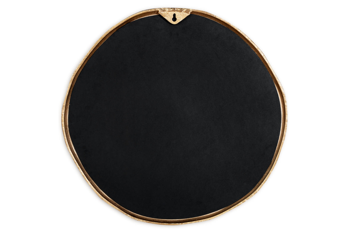 The nkuku Mchanga Organic Shape Mirror features a round, irregular black design with a slim antique brass border, a keyhole hanger at the top, and a smooth, subtle matte surface—all set against a white background.