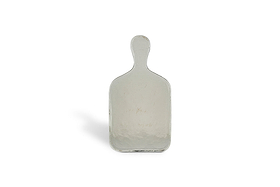 The Komal Serving Platter - Clear by nkuku is a small, rectangular glass platter with a rounded handle, standing upright on a plain white background and casting a faint shadow to the left.