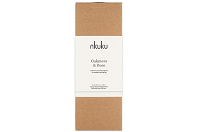 A rectangular brown cardboard box with a white band featuring the nkuku logo showcases the Oakmoss & Rose Scented Reed Diffuser – Yellow, known for its elegant floral and woody fragrance.