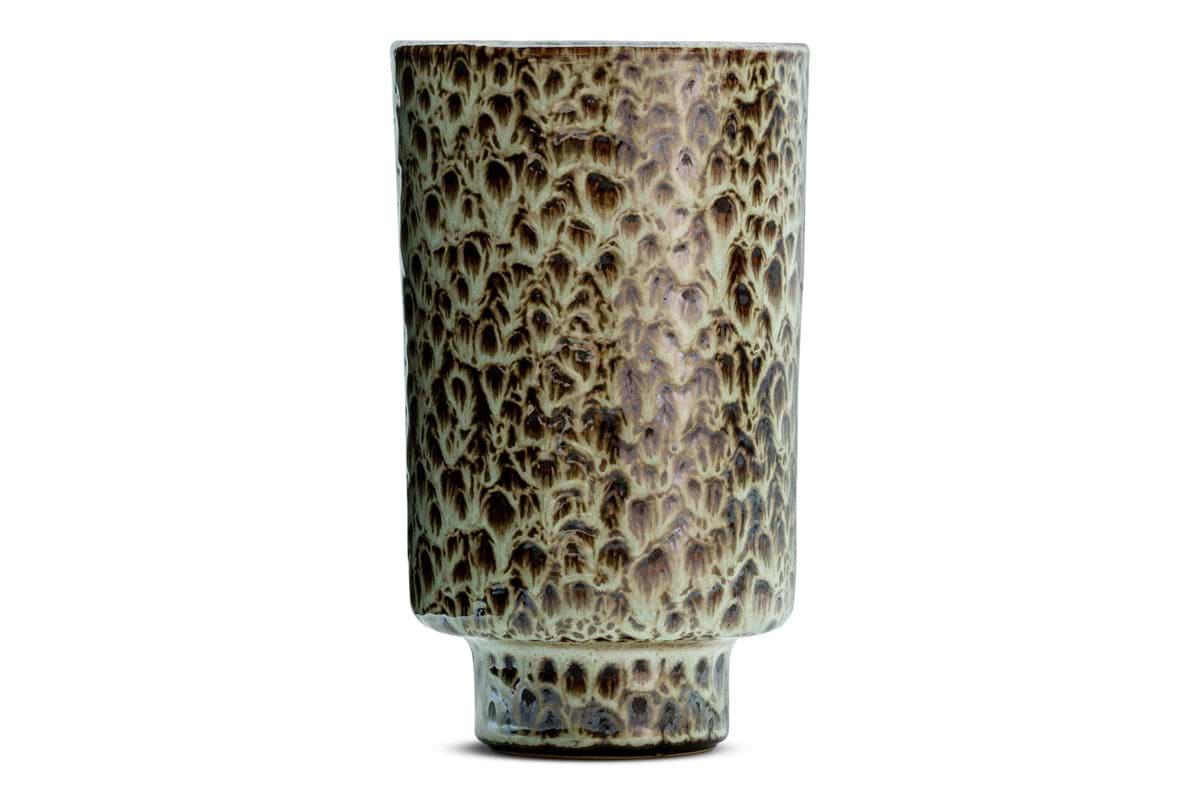 The Uzuri Vase - Brown - Tall by nkuku is a tall ceramic sculptural vase with a cylindrical form and a narrow base. Glazed in mottled earthy brown and green tones, this decorative piece features a textured, scale-like surface pattern reminiscent of animal skin or tree bark. The brown Uzuri Vase is shown against a plain white background.