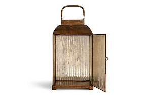 The Ruala Lantern - Brass & Clear by nkuku features a rectangular shape with ribbed clear glass panels and a subtly distressed brass finish. A sturdy metal handle sits on top, while the front door is open to showcase its spacious interior—perfect for adding candlelight. Set against a plain white background.