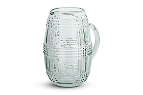 The nkuku Kaanch Jug - Clear features a spacious handle and an embossed check pattern across its glass surface. The empty jug is set against a plain white background, showcasing its prominent pouring spout at the top.