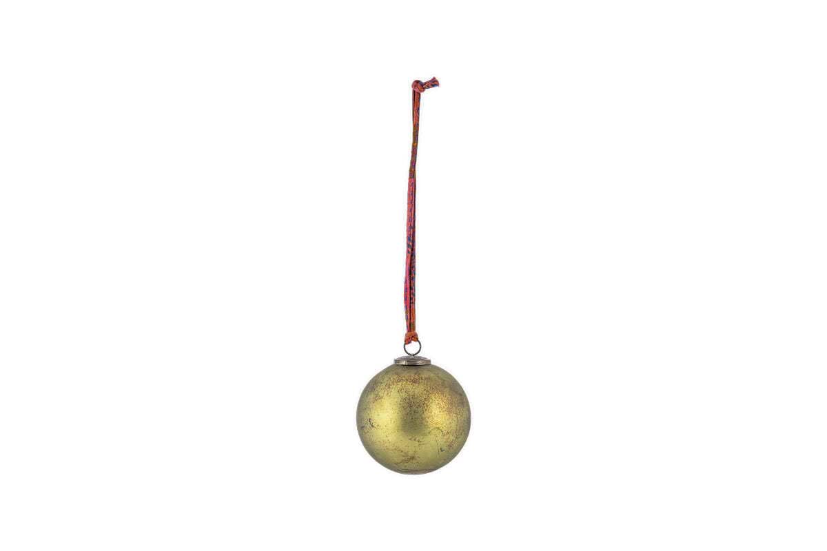 The Oko Giant Bauble - Matt Green by nkuku hangs from a red and white string against a plain white background, adding classic festive charm to your Christmas decor with its slightly worn, matt green finish.