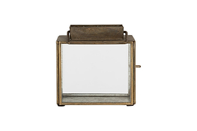 The Obi Mini Table Lantern by nkuku features an antique brass square frame, glass sides, a rectangular handle on top, and a glass door for easy access, shown against a plain white background.