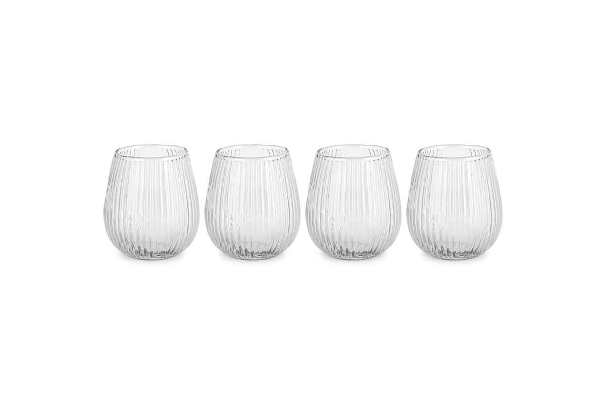The nkuku Otuba Tumbler - Clear (Set of 4) features four ribbed, recycled glass tumblers arranged in a row on a white background, bringing elegant tableware style to any setting.