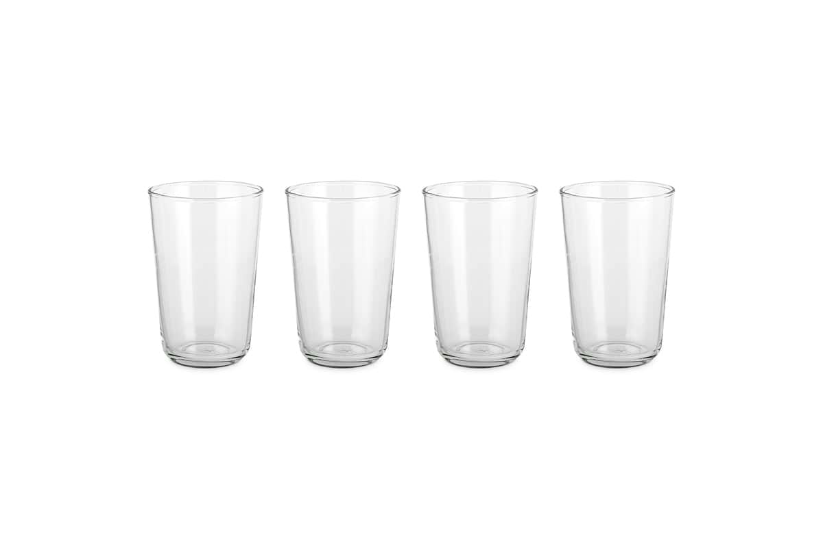 The nkuku Pani Highball - Clear (Set of 4) features four elegant glass tumblers, ideal for everyday dining, displayed in a row on a plain white background to highlight their simple, refined design.