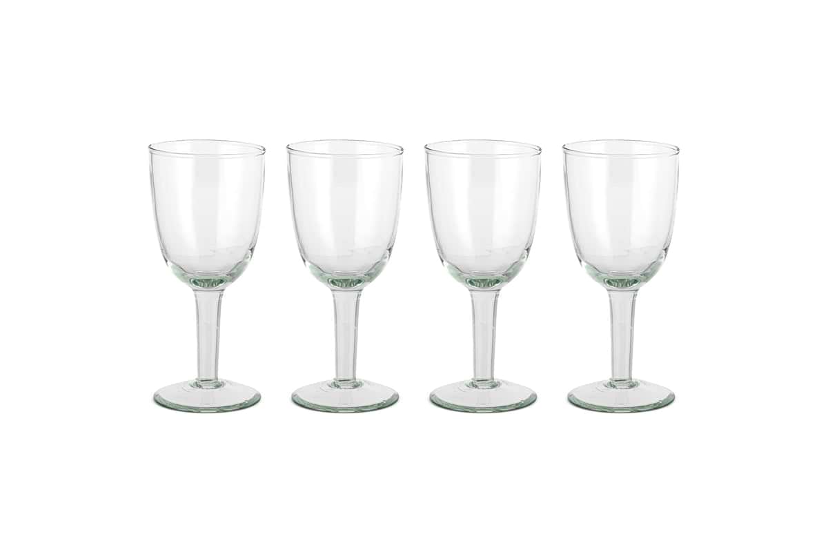 The nkuku Pani Wine Glass - Clear (Set of 4) features four durable glasses in a row on a plain white background, ideal for everyday dining.