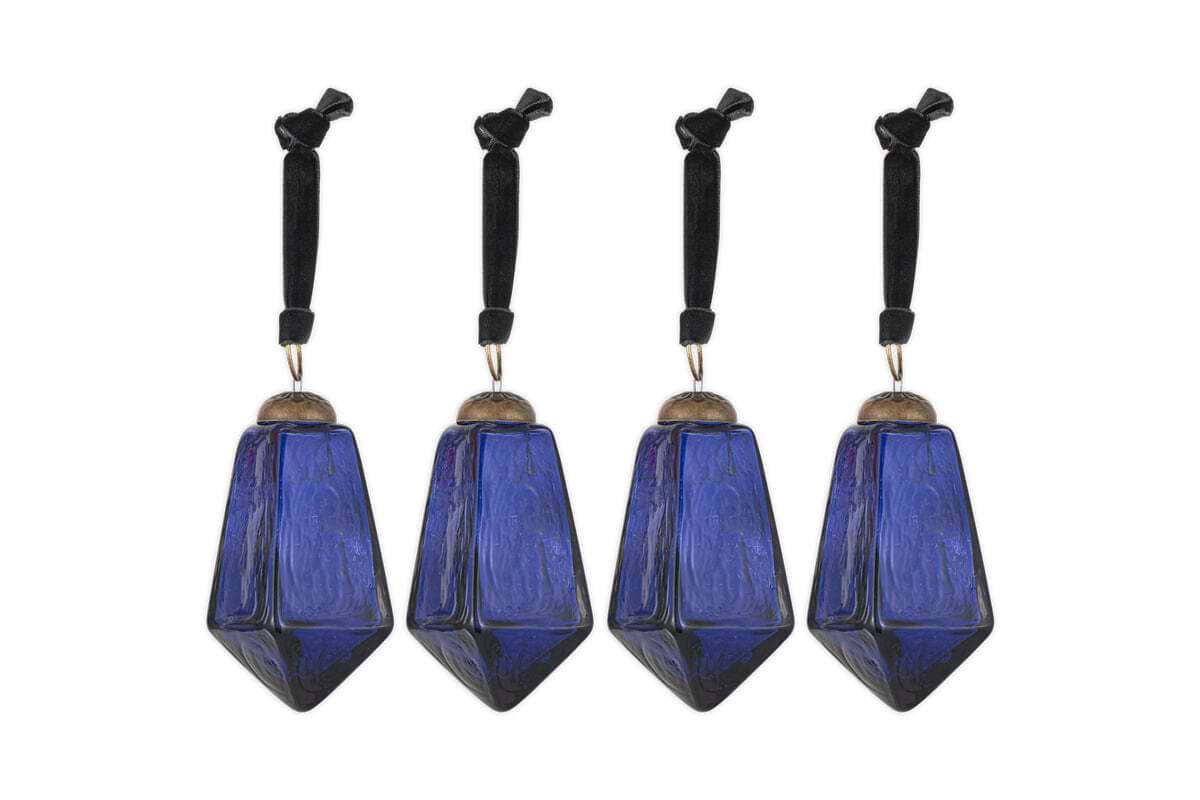 The nkuku Ratnam Baubles - Indigo - Large (Set of 4) feature geometric, faceted deep blue glass with an antique finish, textured surfaces, silver-colored caps, and black cords—bringing classic elegance to your holiday decor.