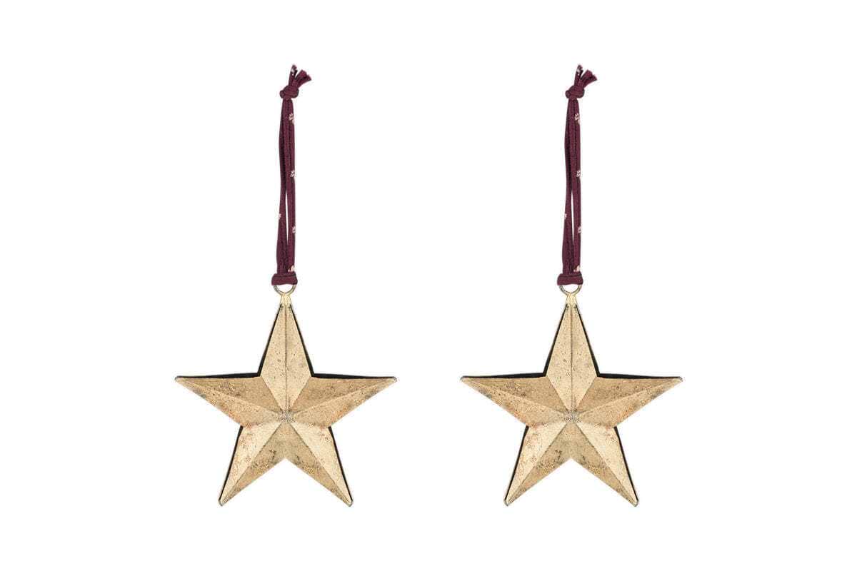 The nkuku Roshani Star Baubles - Antique Brass (Set of 2) feature five-pointed gold stars with a textured finish, hanging from burgundy ribbons and perfect for festive decor.