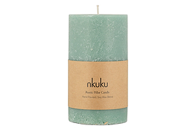 The nkuku Rustic Soy Blend Pillar Candle in Sage Green (Large) features a textured finish and a tan paper label reading: nkuku, Rustic Pillar Candle, Hand Poured, Soy Wax Blend.