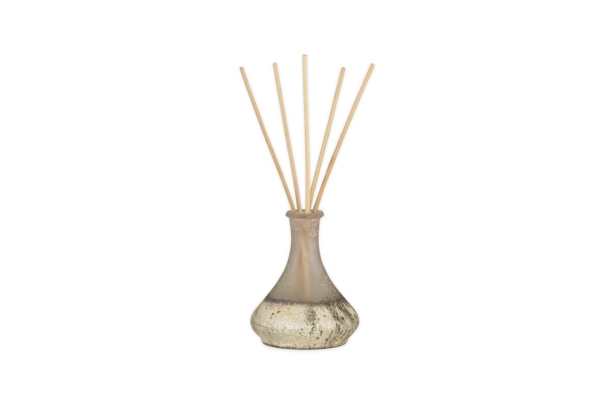 The nkuku Sea Salt & Moss Reed Diffuser fills your room with a bespoke scent. Its glass bottle with a rounded base and slim neck holds fragrance liquid and wooden reeds for effortless aroma diffusion.
