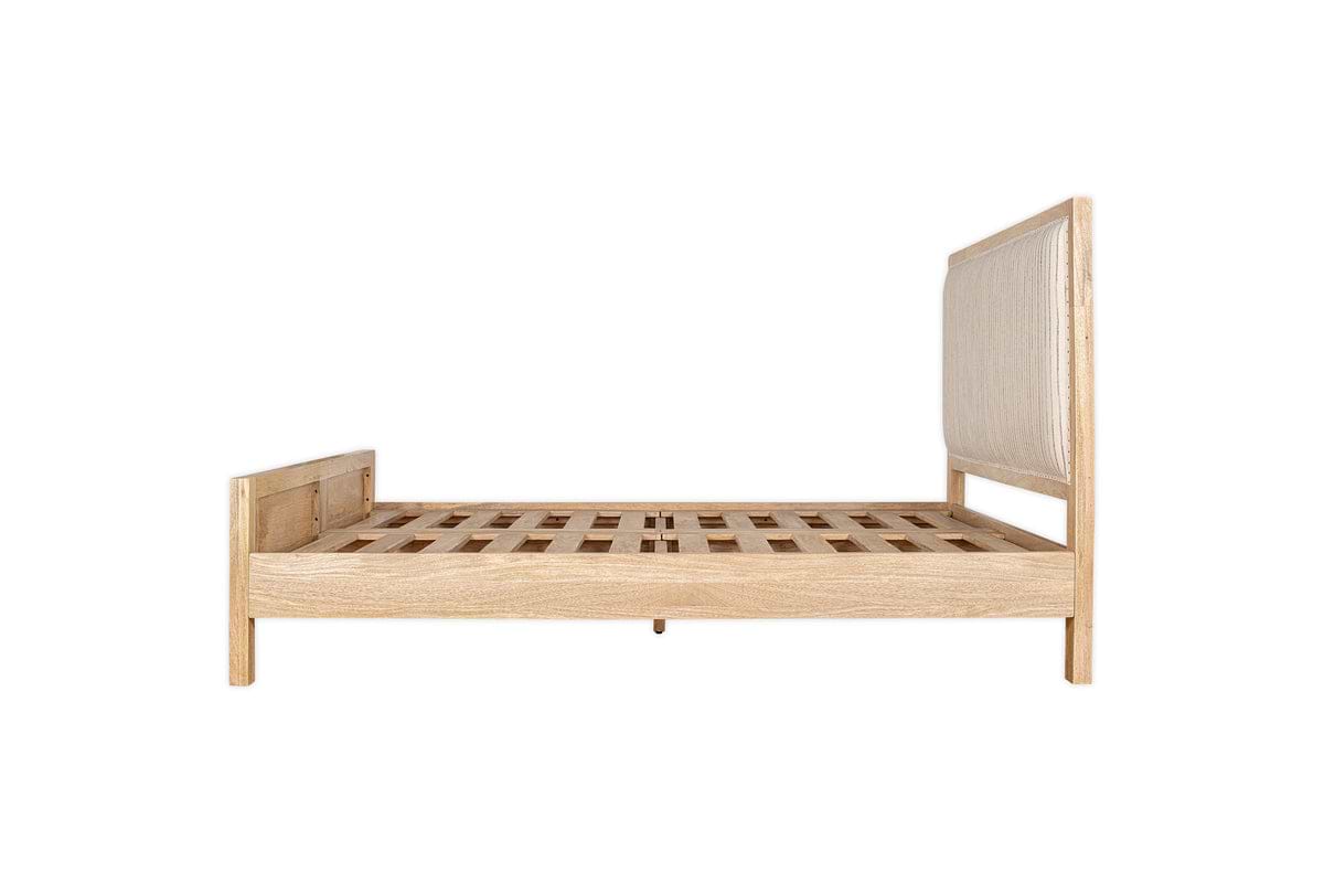 Side view of the Sanja Stripe Bed - Natural by nkuku, crafted from solid mango wood with a slatted base and cotton headboard. The simple, modern design features light tones and stands out against a white background.
