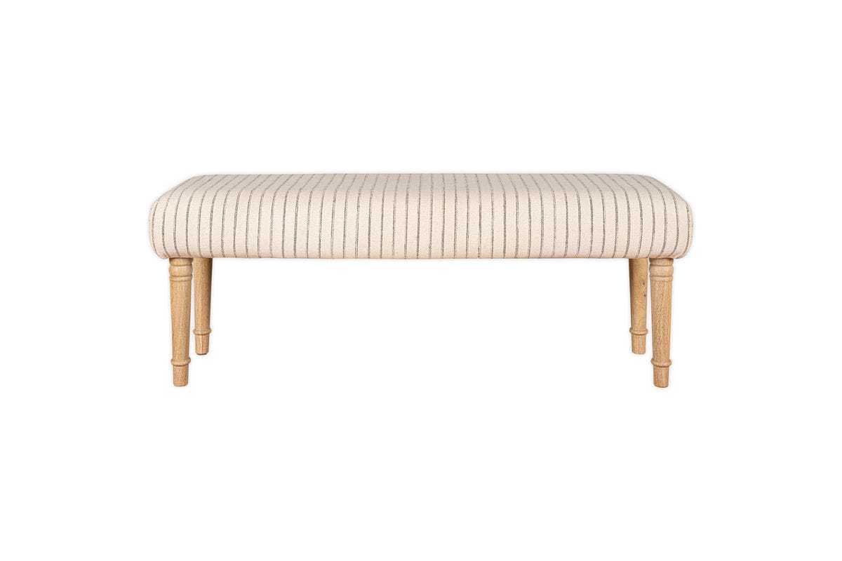 The Sanja Stripe Upholstered Bench by nkuku features a rectangular design, light wood legs, and a cushioned grey seat with thin vertical black stripes, shown against a white background.