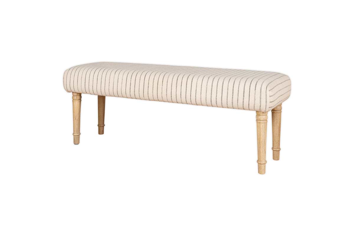 The nkuku Sanja Stripe Upholstered Bench in grey features natural cotton upholstery with striped design and four light wooden legs, ideal for placing at the end of a bed. Shown against a white background.
