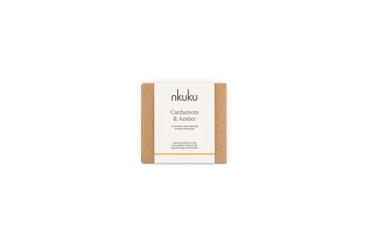 A Cardamom & Amber 1 Wick Scented Candle by nkuku in minimalist brown packaging, featuring sandalwood notes. The natural blend and handcrafted design evoke warmth and comfort.