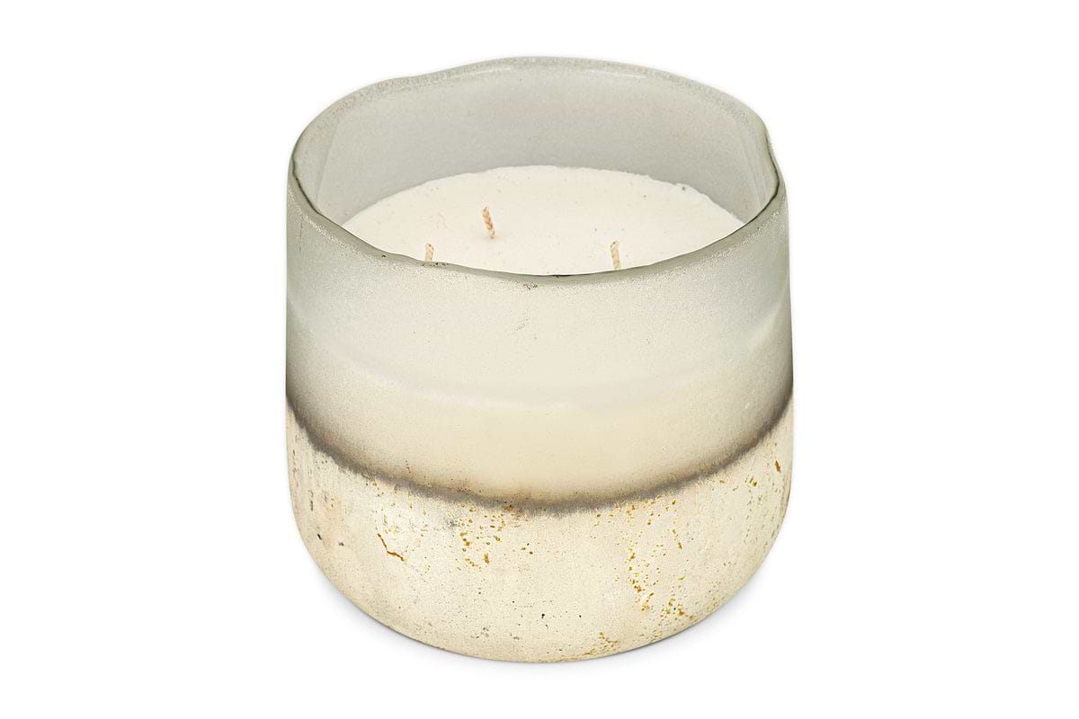The nkuku Sea Salt & Moss 3 Wick Scented Candle comes in a round, semi-transparent glass holder with a frosted white-to-speckled gold and beige gradient and features a UK-inspired fragrance.