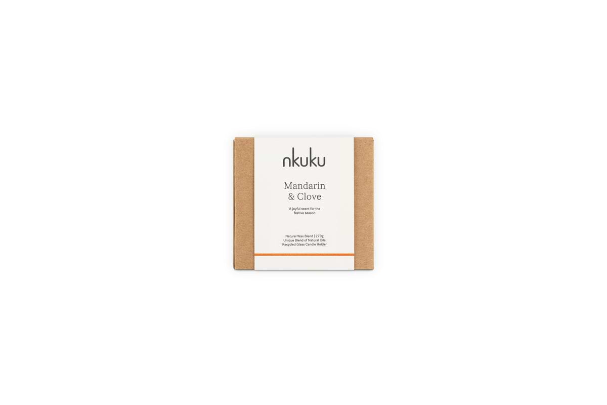 A square brown cardboard box with a white nkuku label holds the Mandarin & Clove 1 Wick Scented Candle, evoking a festive spiced mandarin fragrance, set against a plain white background.