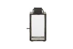 The nkuku Sia Mini Table Lantern - Black features a rectangular metal frame, clear glass panels, side latch, tealight holder, and a top handle; its shown against a white background.