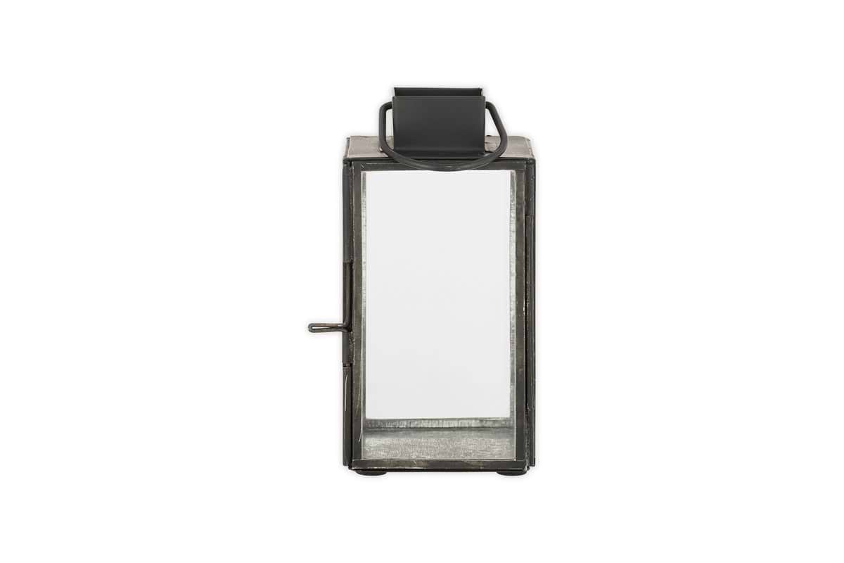 The nkuku Sia Mini Table Lantern - Black features a rectangular metal frame, clear glass panels, side latch, tealight holder, and a top handle; its shown against a white background.
